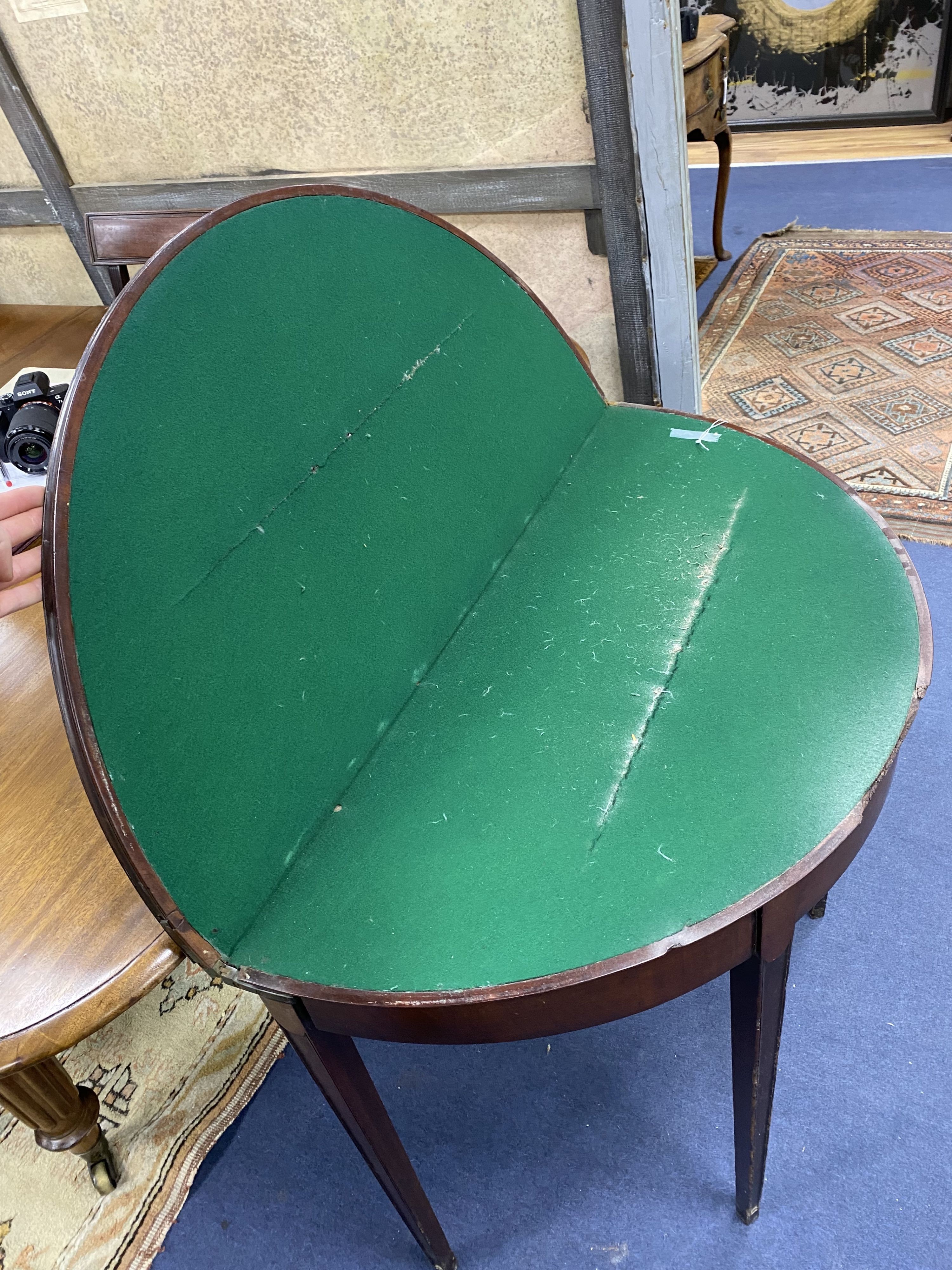 A George III mahogany 'D' shaped folding card table (top split), width 90cm, depth 46cm, height 74cm